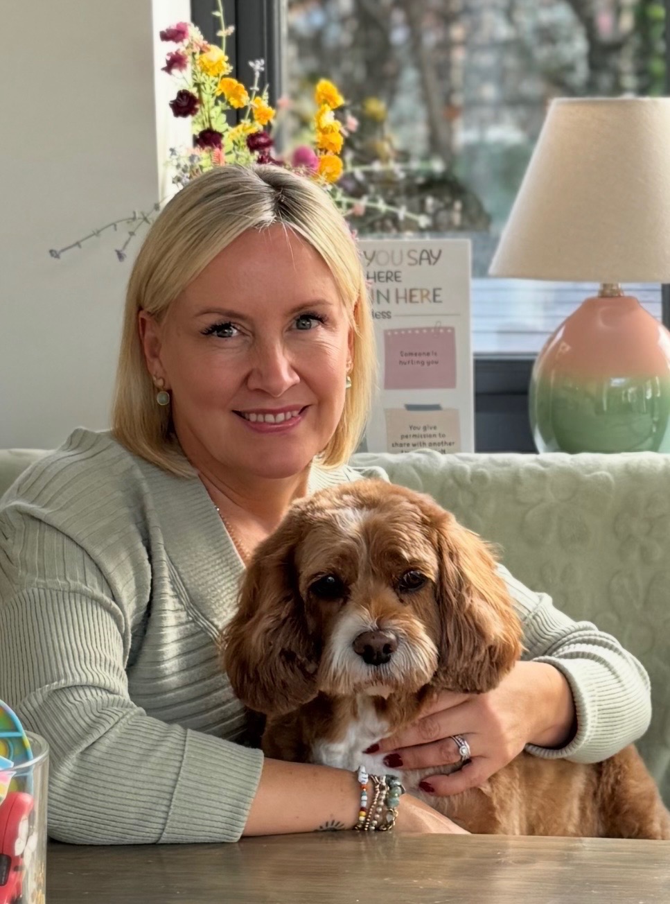 Verity with Ivy the therapy dog in the Bloom room